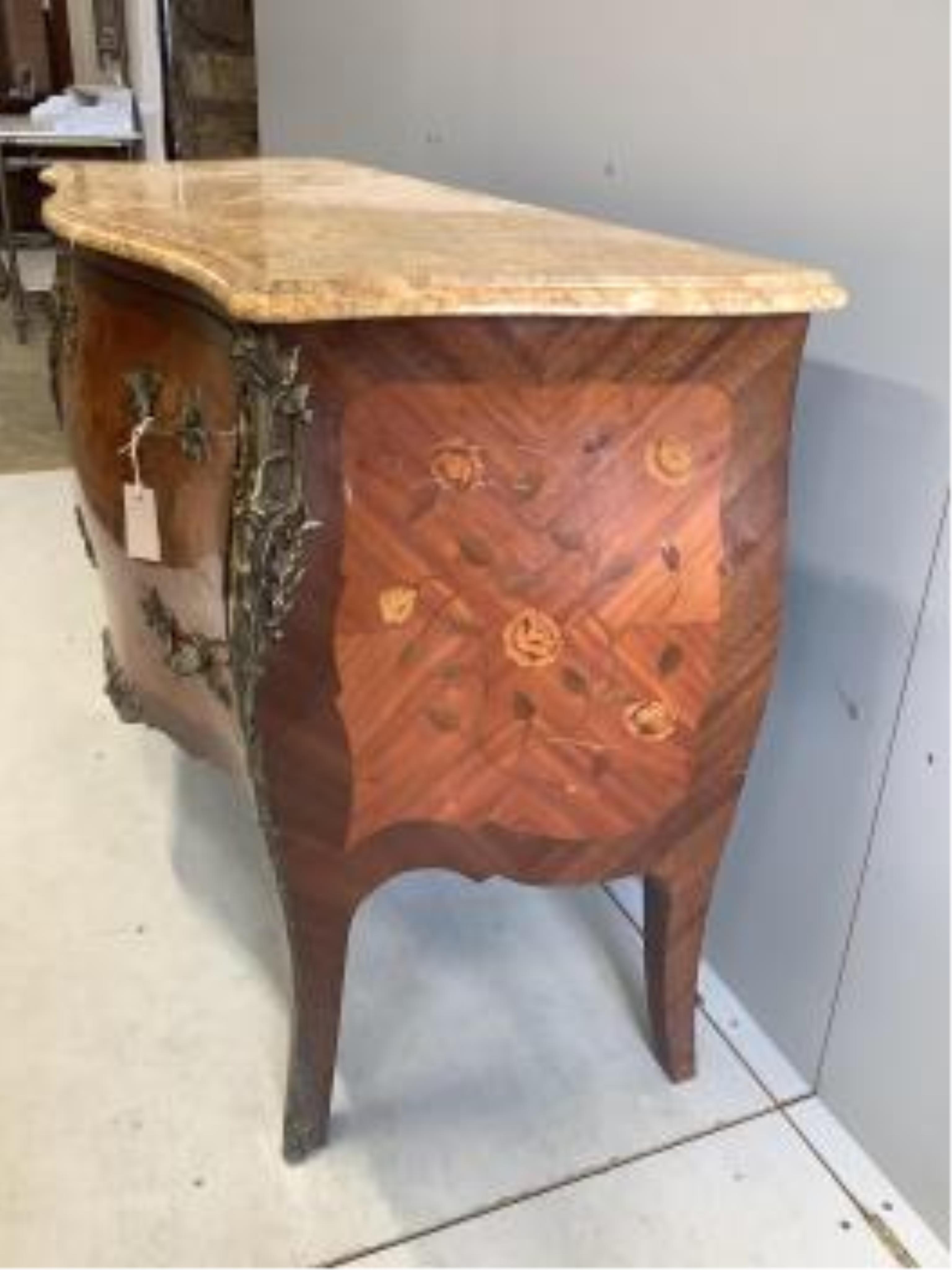 A Louis XVI style marquetry inlaid gilt metal mounted marble topped bombe commode, width 122cm, depth 51cm, height 86cm